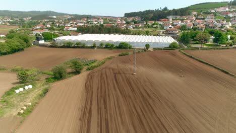 Aerial-View-Of-Rural-Field-And-Greenhouses