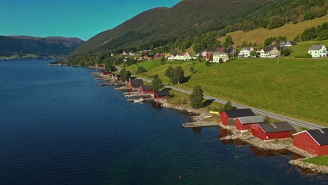 Aerial-over-Syvde-waterfront-on-a-lovely-sunny-day,-Vanylven-Municipality,-Norway
