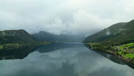 Aerial-over-the-waters-of-Syvdsfjorden-near-Syvde-on-a-cloudy-day,-Vanylven-Municipality,-Norway