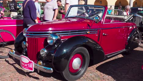 A-vintage-convertible-car-exhibited-during-a-classic-car-meeting-on-Waltherplatz-Square-in-Bozen---Bolzano,-South-Tyrol,-Italy