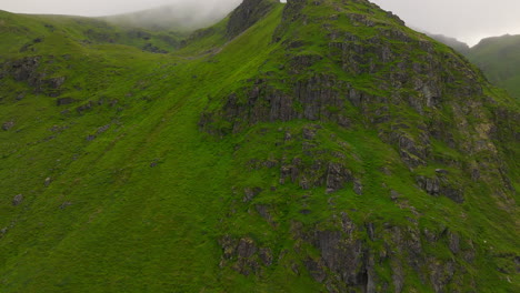 Montañas-Verdes-Y-Escarpadas-Cerca-De-La-Costa-De-Yttersand-En-La-Bahía-De-Sandbotnen,-Lofoten,-Noruega