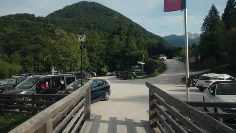 Walking-POV-along-bridge-to-parking-lot-at-the-entrance-of-Almbachklamm-on-a-warm-sunny-day