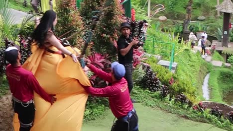 Girl-in-a-long-train-dress-riding-swing-with-rice-field-terraces-view-for-photo-shoot-in-Bali