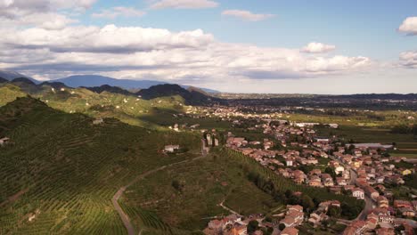Aerial-panoramic-landscape-view-over-the-famous-prosecco-hills-with-vineyard-rows,-Italy,-on-a-cloudy-evening