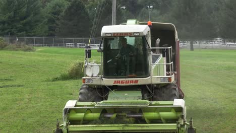 Claas-Jaguar-forage-harvester-driven-by-farmer-and-son-in-buddy-seat