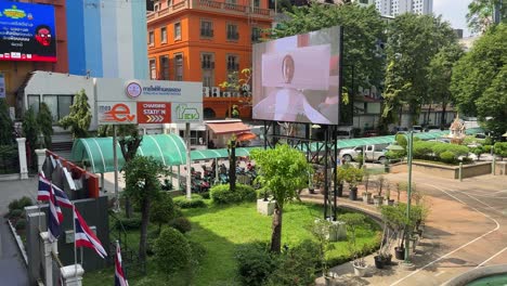 View-of-the-signage-board-of-the-electric-car-charging-station-against-buildings-in-downtown-Bangkok,-Thailand