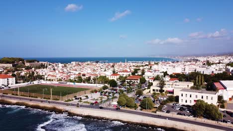 Sea-waves-rolling-towards-coast-of-Rethymno-town,-aerial-view