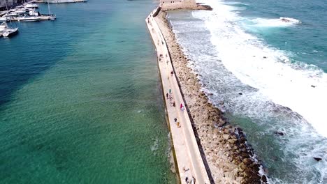 Waves-flowing-over-breakwater-in-Chania,-aerial-drone-view
