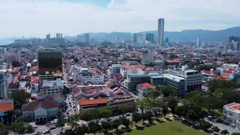 The-vast-city-of-Penang-and-the-towering-Paragon-Mall-Skyscraper,-aerial