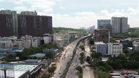 Close-aerial-footage-of-the-Old-Mumbai-Highway-and-biodiversity-one-way-flyover-990-meters-long-starts-at-the-DivyaSree-Orion-SEZ-and-ends-at-the-Biodiversity-Junction,-going-in-the-direction-of-IKEA