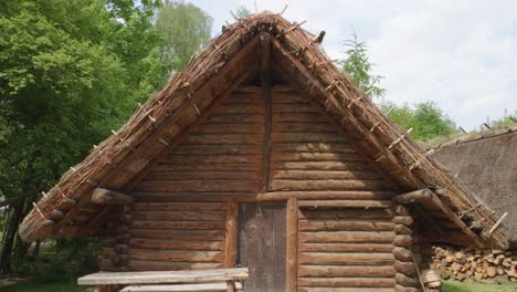 Ancient-Wooden-Slavic-House---Biskupin,-Poland---Pan-Up