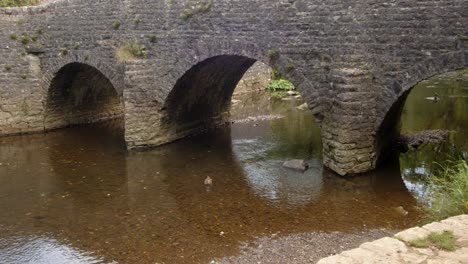 mid-shot-of-stone-bridge-at-Wetton-mill-looking-east