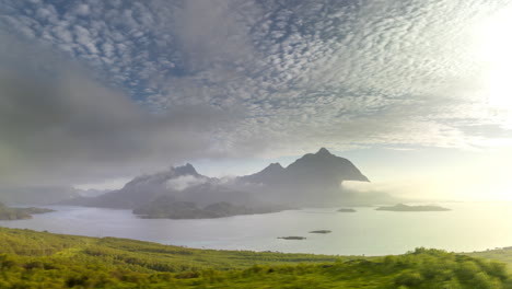 Ethereal-cloudscape-and-time-motion-with-Strona-mountain-peak,-Norway-coastal-scenery