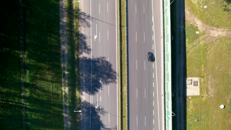 Aerial-top-down-shot-of-cars-on-highway-in-suburb-area-of-Gdynia-during-sunny-day