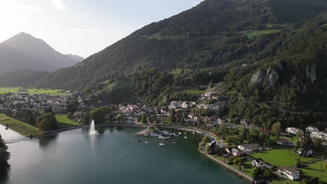 Aerial-view-of-Weesen-town-based-near-shore-of-Walensee-lake,-Switzerland