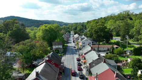 Historic-American-miners'-village-with-brick-and-stone-houses,-set-in-a-hilly-landscape-with-modern-cars-lining-the-streets