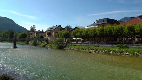 Panoramic-Shot-of-River-Traun-Flows-Through-Spa-Town-Bad-Ischl-on-Sunny-Day-with-Bridge-in-Background