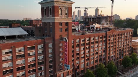 Panoramic-aerial-view-of-Ponce-City-Market-building-exterior-with-rooftop-amusement-park-and-people,-Atlanta,-Georgia,-USA