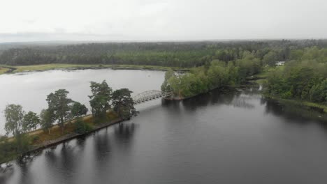 Wide-view-of-old-train-bridge-near-Piksborg-Sweden,-aerial