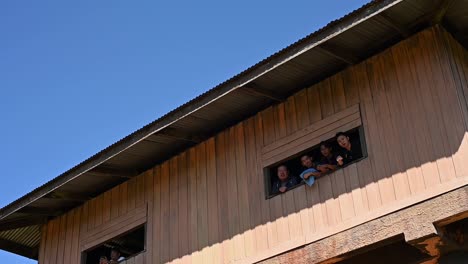 People-looking-out-a-wide-window-at-an-observation-tower-in-Khao-Yai-National-Park,-Thailand
