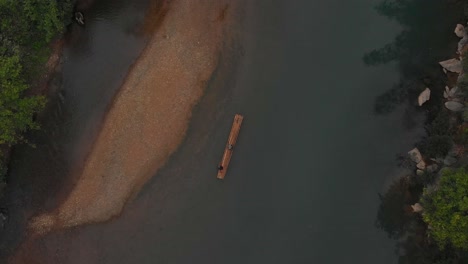 Top-down-view-of-bamboo-raft-on-Niem-son-river-Vietnam,-aerial