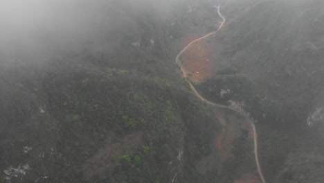 Tilt-up-shot-of-mountain-pass-at-Cao-bang-Vietnam,-aerial