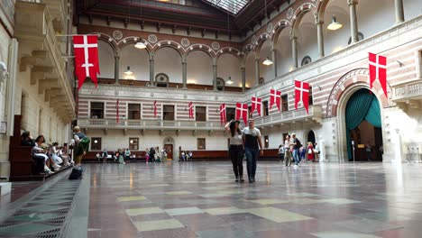 Static-shot-of-a-couple-checking-the-interior-of-Copenhagen-city-hall