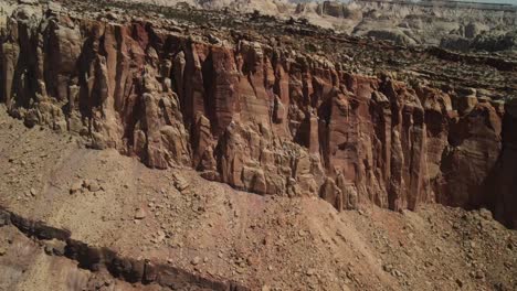 An-intimate-examination-of-drone-footage-of-a-stone-wall-formation-within-Capitol-Reef-offers-a-distant-glimpse-of-the-horizon