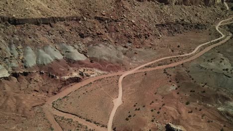 The-drone-footage-of-Capitol-Reef,-an-intriguing-double-pathway-emerges,-resembling-either-a-road-or-a-river,-creating-an-unusual-pattern-in-the-landscape