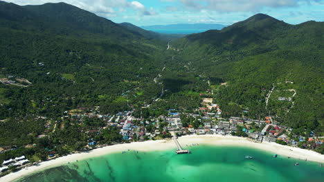 Aerial-view-of-Chaloklum-Beach-surrounded-by-mountains-and-jungle-on-all-sides,-Koh-Phangan,-Thailand