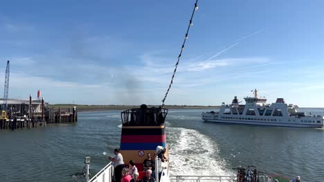 Slow-motion-pov-on-leaving-german-ferry-at-port-of-Norderney-Island-meeting-arriving-ferry-ship-in-summer