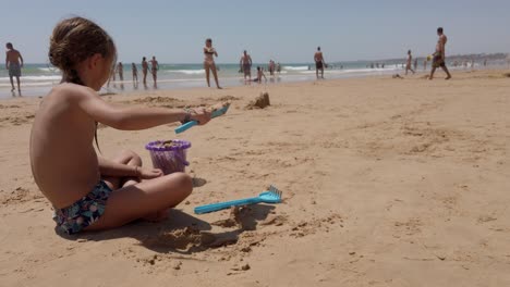 El-Calor-Del-Verano-Arriba,-La-Niña-Se-Divierte-Sola-En-La-Arena.