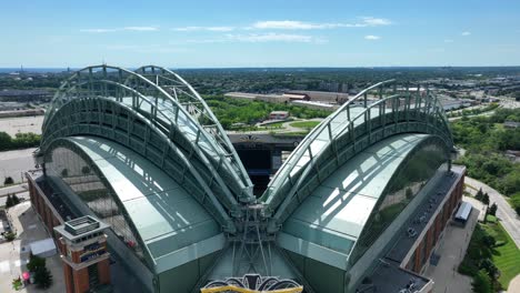 American-Family-Field,-with-its-iconic-retractable-roof,-stands-majestically-amid-a-city-backdrop,-its-brick-facade-complemented-by-green-metalwork