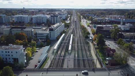Railroad-tracks:-Train-leaves-Kerava-station-heading-to-Helsinki,-FIN