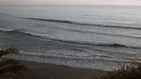 A-view-of-the-ocean-waves-during-sunset-at-Swamis-Beach-in-Encinitas,-California