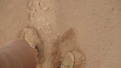 Point-of-view-slow-motion-shot-walking-in-the-desert-in-boots-through-sand