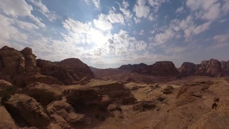 Standing-on-the-edge-of-a-cliff-overlooking-Petra,-Jordan