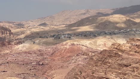 A-view-of-the-town-of-Wadi-Musa-from-across-the-mountains-above-Petra,-Jordan---panorama