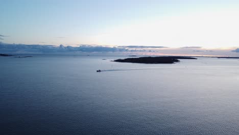 Evening-blue-light-aerial:-Lone-fishing-ship-motors-through-Baltic-Sea