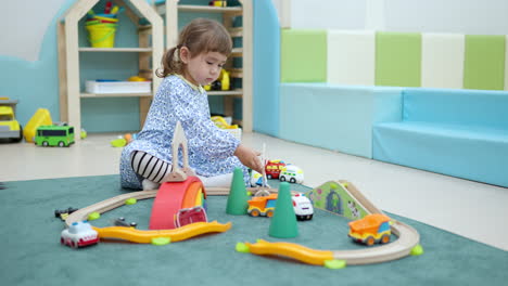 Child-toddler-playing-toy-cars-on-the-floor