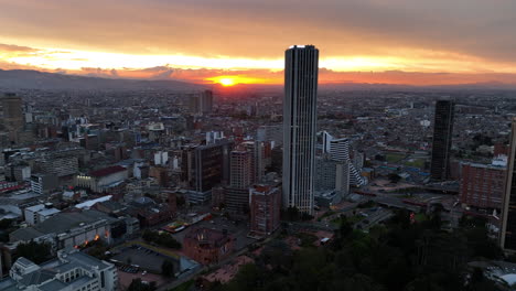 Aerial-view-toward-the-Torre-Colpatria-skyscraper,-sunset-in-Bogota,-Colombia