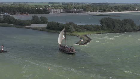 Big-traditional-dutch-sailing-vessel-on-ijsselmeer-near-Makkum,-aerial