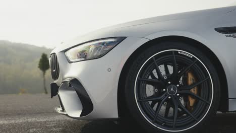 White-Mercedes-AMG-GT-63S-car-front-and-side-closeup-view-with-sun-reflection