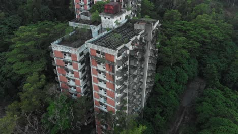 Aerial-view-of-old-abandoned-highland-towers-in-green-vegetation-at-Kuala-lumpur
