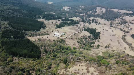 Drone-aerial-over-a-lush-Australian-native-mountain-with-trees-that-has-been-partly-cleared