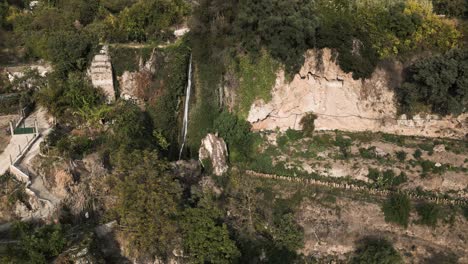 Rocky-terrain-and-majestic-waterfall-in-Spain,-aerial-view