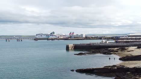 Aerial-view-across-Holyhead-harbour-coastline-with-Irish-ferry-ship-in-Welsh-port-terminal
