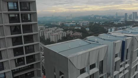 Flying-low-over-Tamarind-Suites-Cyberjaya-and-reveal-the-landscape,-aerial