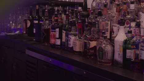 Slow-revealing-shot-of-a-large-selection-of-alcohol-bottles-for-purchase-in-a-bar