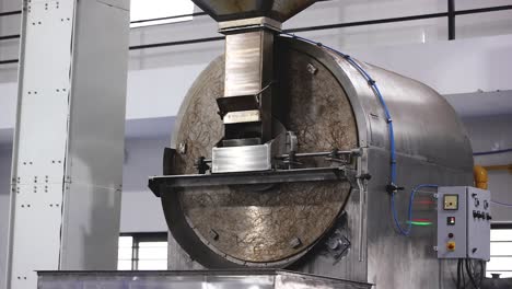 In-the-peanut-butter-manufacturing-process,-peanut-kernels-are-rotated-in-a-machine-to-heat-them